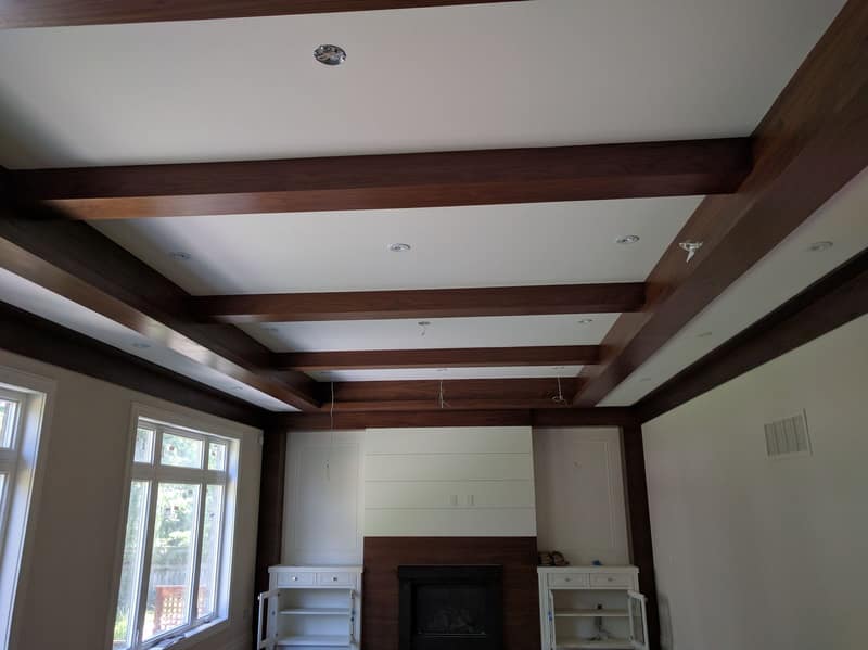 Family room with a stained wood coffered-beam ceiling