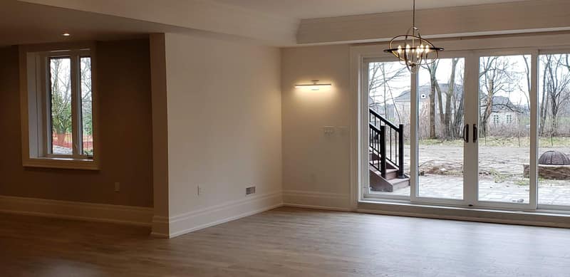 Open main floor with feature-wall panelling, fresh paint and hardwood throughout